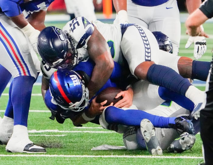 Seattle Seahawks defensive end Dre'Mont Jones (55) and linebacker Uchenna Nwosu (10) sack New York Giants quarterback Daniel Jones (8) in the second half at MetLife Stadium.